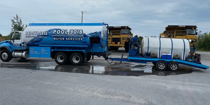 Bulk water delivery tanker filling a large storage tank in Ottawa