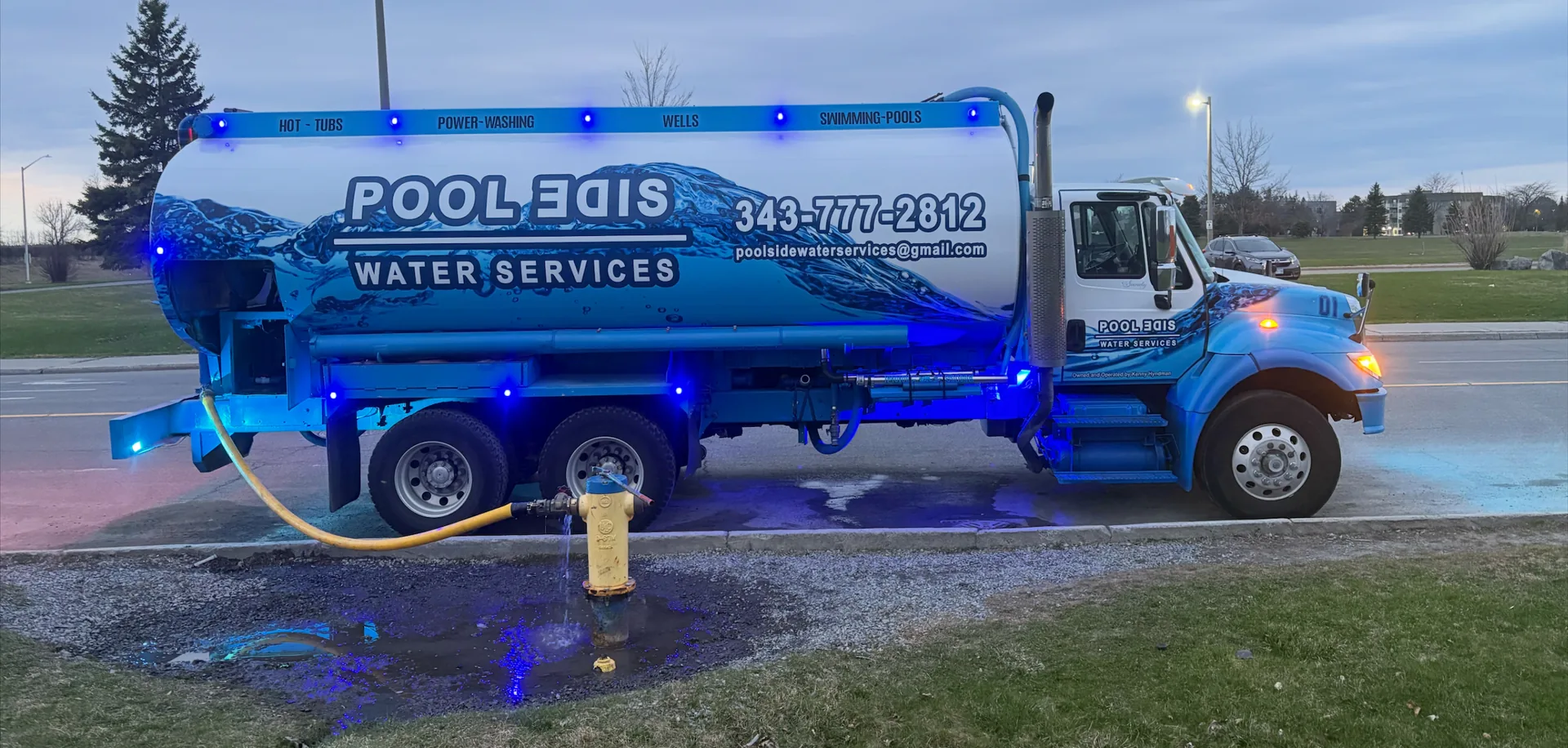 Pool Side Water Services branded tanker truck connected to a fire hydrant at dusk in Ottawa